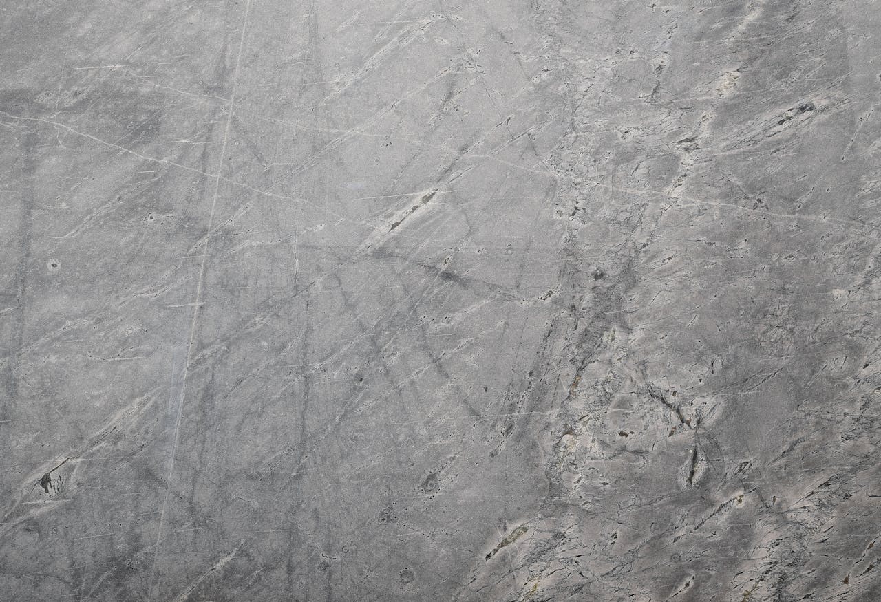 Close-up of a textured grey stone surface suitable for backgrounds or wallpapers.